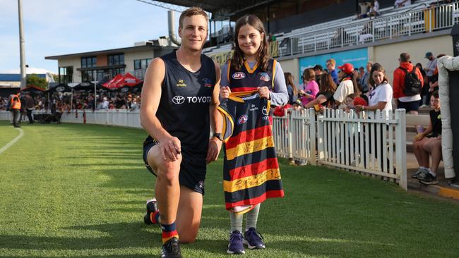 Adelaide captain Jordan Dawson with a young fan during Gather Round. Picture: David Mariuz