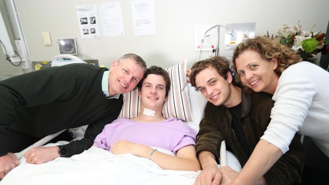 Conor Tweedy in hospital with his parents Sean and Beck and brother Seamus. Picture: Annette Dew