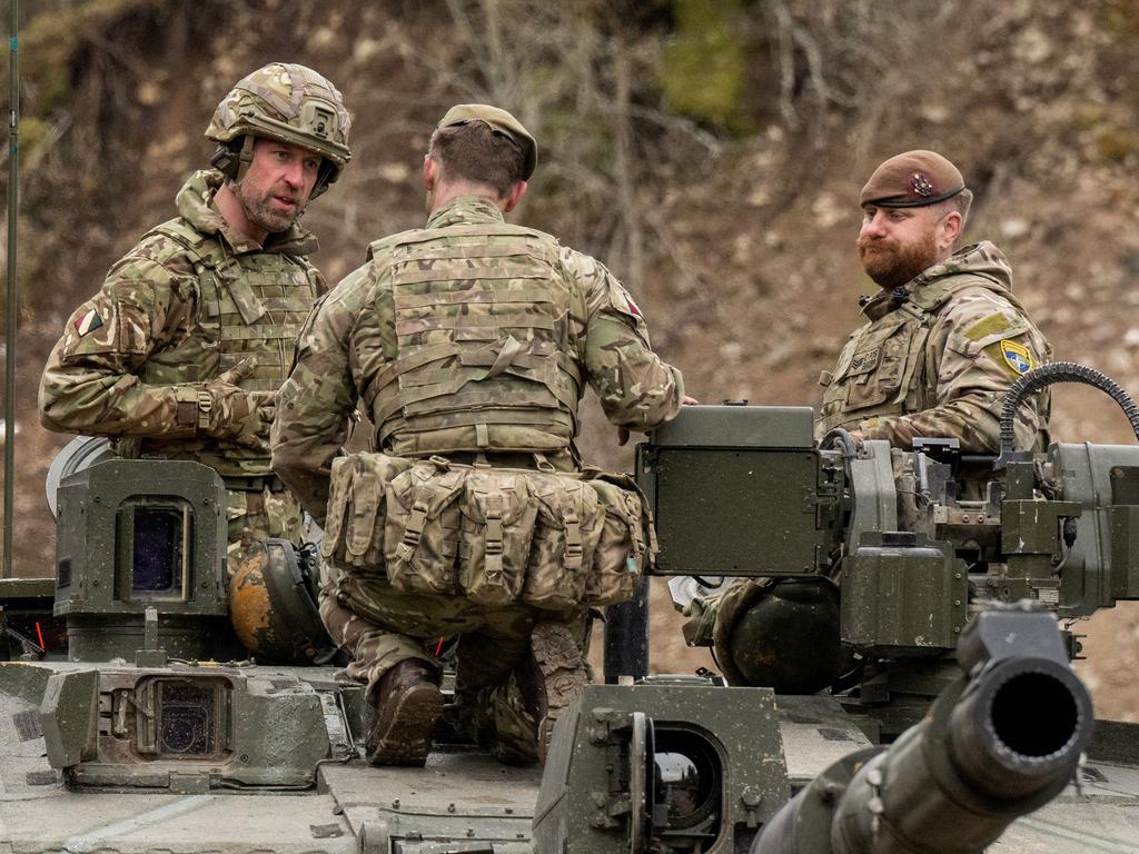 Prince William speaks to soldiers on top of a Challenger 2 tank while visiting British service personnel at the Tapa Army Base. Picture: AFP