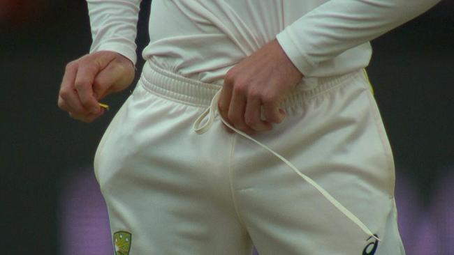 <b>3.</b> After talking to Handscomb, Bancroft attempts to cover up his dirty work by putting the yellow tape down the front of his pants — supposedly safe from prying eyes. This is all captured on camera.