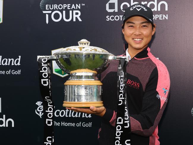 NORTH BERWICK, SCOTLAND - JULY 11: Min Woo Lee of Australia celebrates with the trophy after winning the abrdn Scottish Open at The Renaissance Club on July 11, 2021 in North Berwick, Scotland. (Photo by Andrew Redington/Getty Images)