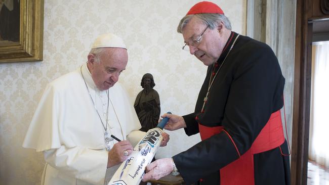 Pope Francis speaks with Cardinal George Pell at the Vatican. Picture: REUTERS/Osservatore Romano/Handout via Reuters