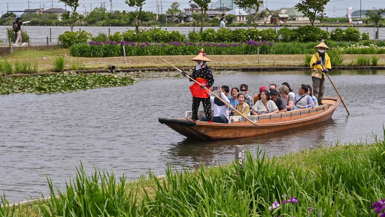 Tourists taking a boat ride at Suigo Sawara Ayame Park in the city of Katori, Chiba prefecture, north of Tokyo. (Photo by Richard A. Brooks / AFP)