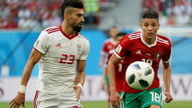 Ramin Rezaeian keeps his eye on Morocco’s Amine Harit. Picture: Getty.