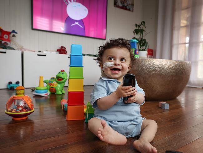 Harlen is finally back home with his favourite toy, the TV remote control. Picture: David Caird