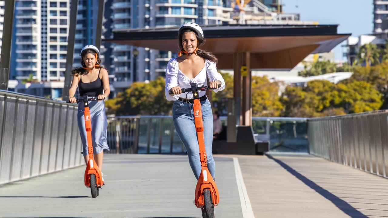 Lola Burette from Belgium (front) and Jeanne Marteau from France with Neuron Scooters at New Farm Riverwalk. Picture: Richard Walker