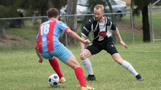 Ipswich City Bulls footballer Zygan Condie defends against Ipswich Knights striker Matthew Haspels during a trial match this year. Picture: Gary Reid