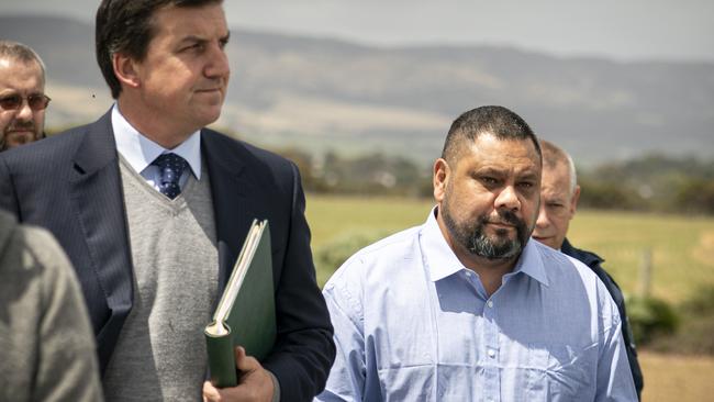 Paul Beveridge Maroroa (light blue shirt) surrounded by security and legal representatives at Gull Rock car park. Picture: AAP/Mike Burton