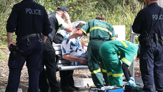 Police watch on as paramedics treat a suspected drug overdose at Festival X. Picture: David Swift