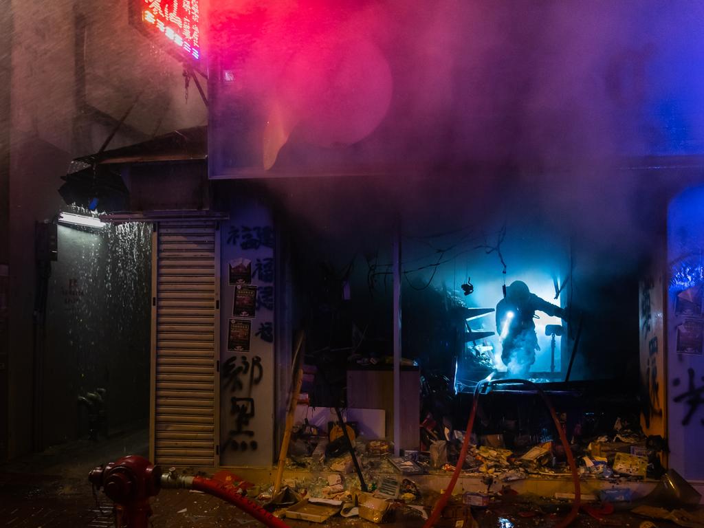 Firemen work to put out a fire in a shop during a pro-democracy march at Mongkok district in Hong Kong, China. Picture: Getty Images