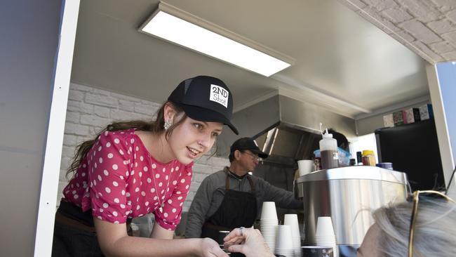 Toowoomba Clubhouse trainer May Volp takes a coffee order for the 2nd Shot food truck run by BASE Services.