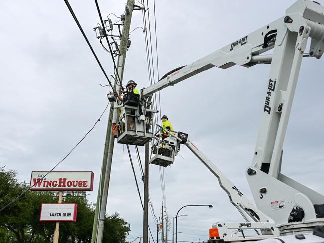 Internet service workers work secure cables in Kissimmee, Florida, ahead of the expected landfall of Hurricane Milton. Picture: Giorgio Viera/AFP