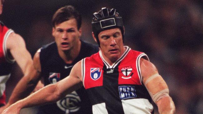 St Kilda champion Nathan Burke gets a kick away during his playing career.