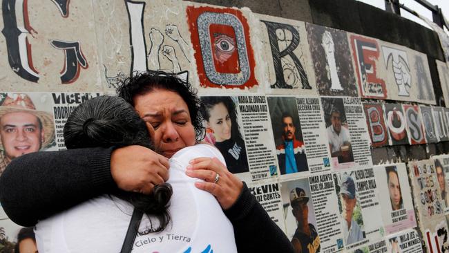 Two women hug at a monument to victims of forced disappearances in Jalisco, Mexico. Picture: AFP