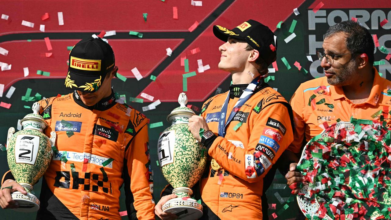 (LtoR) Second placed Team McLaren-Mercedes' Lando Norris, winner Team McLaren-Mercedes' Oscar Piastri and Team McLaren-Mercedes' Racing Director Randy Singh celebrate on the podium after the Formula One Hungarian Grand Prix at the Hungaroring race track in Mogyorod near Budapest on July 21, 2024. (Photo by Attila KISBENEDEK / AFP)