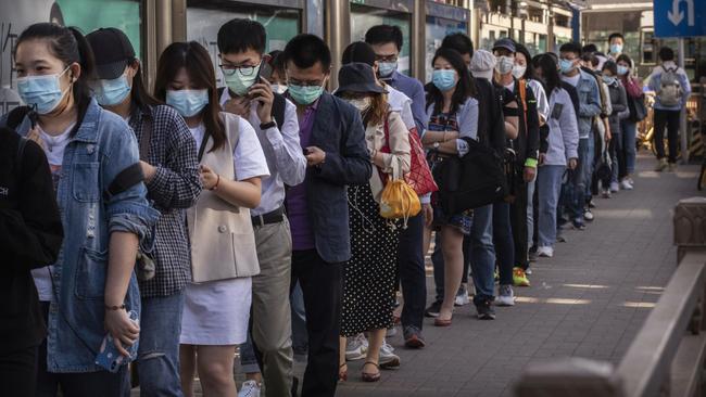 Chinese commuters wear protective masks in Beijing. Picture: Getty Images