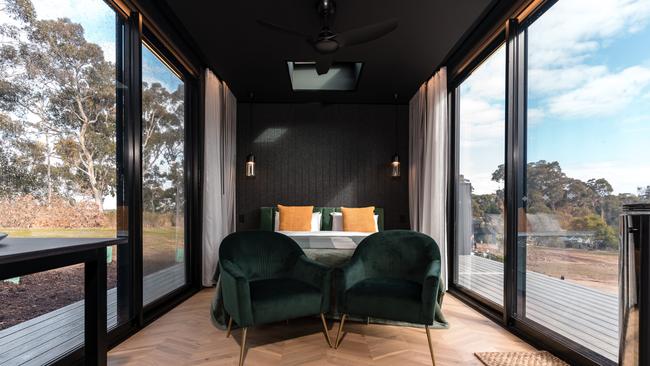 Floor-to-ceiling windows give full view of the cabin’s native surrounds. Picture: CABN