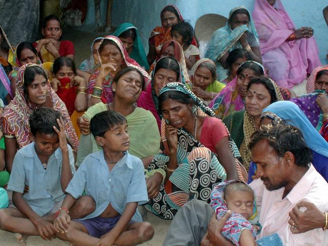 Relatives mourn the death of women who died after undergoing sterilisation surgeries, at a village near Bilaspur, in the central Indian state of Chhattisgarh.