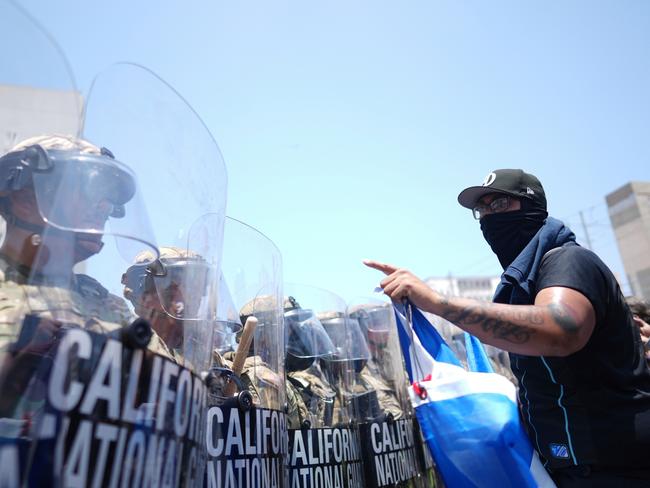 A protester confronts a line of US National Guard in the metropolitan detention centre of downtown Los Angeles. Picture: AP