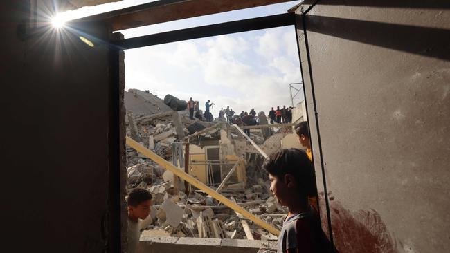 Palestinians inspect the rubble of a building hit in overnight Israeli bombing in Rafah, in the southern Gaza Strip, on April 21.