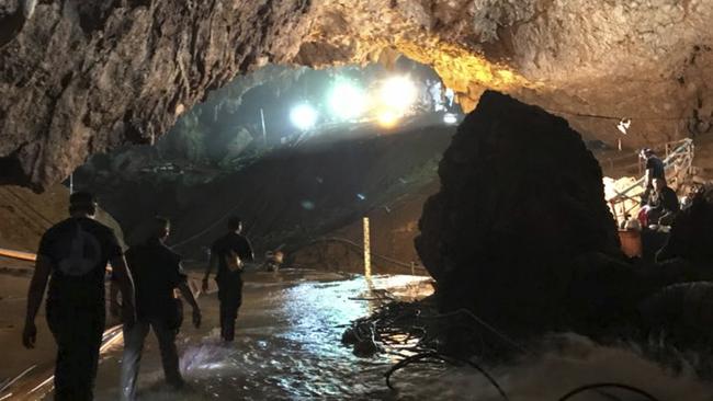 Rescuers move to find trapped members of the youth soccer team from a flooded cave in northern Thailand. Picture: Elon Musk via AP