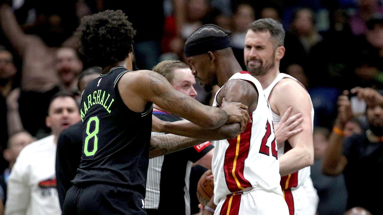 Naji Marshall and Jimmy Butler get involved in an altercation during the fourth quarter as Kevin Love looks on. (Photo by Sean Gardner/Getty Images)