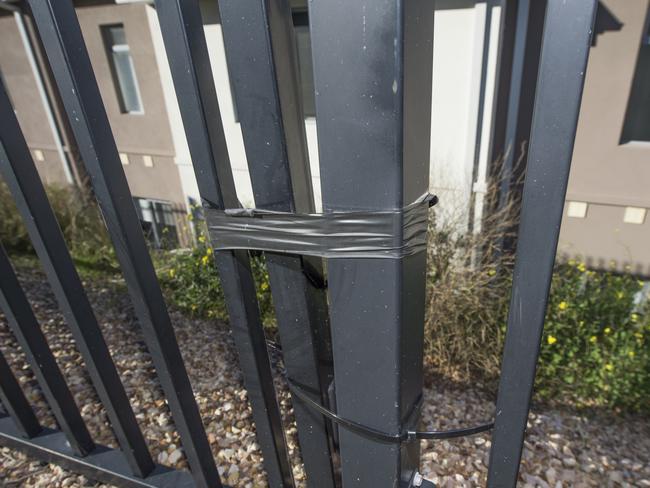 A fence held secured with tape. Picture: Rob Leeson