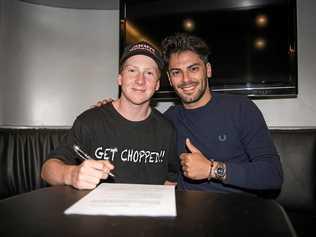 NEW DEAL: Toowoomba's Joel Kelso signs his contract with Leopard CIV team manager Alessandro Tonucci. Picture: Contributed