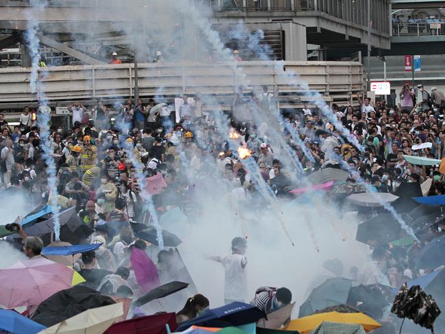 Teargas launched by riot police rains down on the crowd.