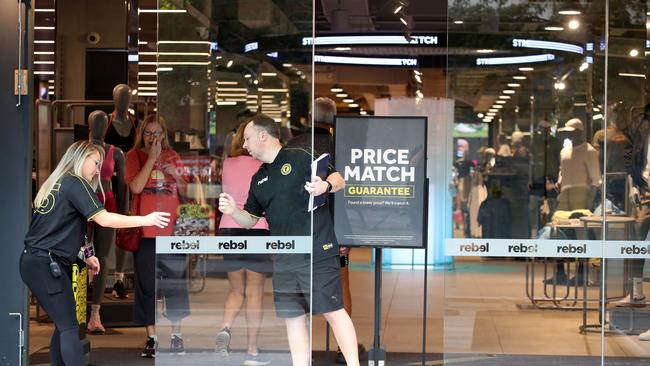 Staff opening Rebel’s doors after police were seen leaving store in Rundle Mall on Wednesday. Picture: Kelly Barnes