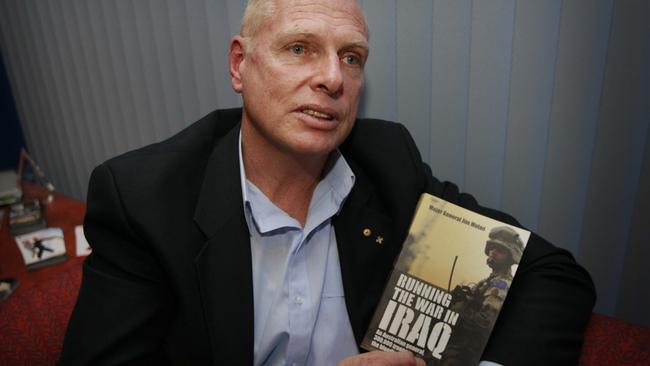 Mr Molan with his book, which details his experiences in Iraq.