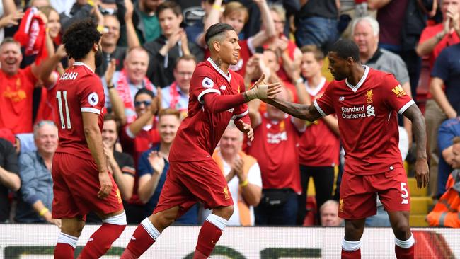 Liverpool's Brazilian Roberto Firmino (C) celebrates.