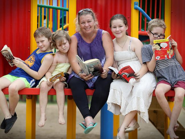 Cyndi Baker reading with her children Nathen, 11, Louieze, 8, Kacy, 13 and Kamb, 10. Picture: Jamie Hanson