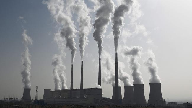 (FILES) This photo taken on November 15, 2021 shows the coal-powered Datang International Zhangjiakou Power Station in Zhangjiakou, one of the host cities for the 2022 Winter Olympic Games, in China's northern Hebei province. As climate envoys from the world's top two greenhouse gas producers meet in Beijing, experts say China's emissions may finally be nearing a peak, though many uncertainties remain. (Photo by GREG BAKER / AFP)