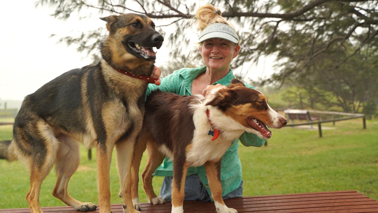 Barbara Massey with her two pups, Malcom the German Shepherd and Narla the Border Collie, trying to get in some outdoor time at Mackay Harbour's North Wall on January 25, 2024, before the winds got too strong from Tropical Cyclone Kirrily. Picture: Heidi Petith