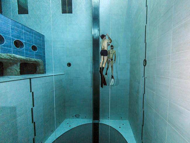 Two swimmers descend into the deepest part of the pool. Picture: Rino Sgorbani/Caters News