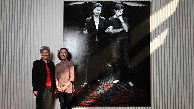 Foreign Minister Penny Wong and artist Tianli Zu unveiling her portrait titled The Senator and Ma, at the Festival Theatre foyer in Adelaide. Picture: Naomi Jellicoe