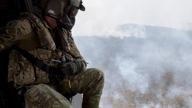 An Australian Army 5th Aviation Regiment loadmaster observes the area near Mount Ginini close to the New South Wales and Australian Capital Territory border.