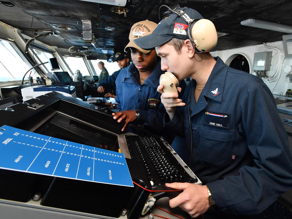 Operations Specialist Zane Hall (right) is seen on the bridge of the USS Ronald Reagan. Picture: AAP Image/Darren England