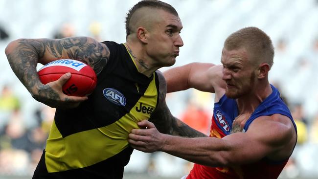 Dustin Martin of the Tigers brushes off his opponent.