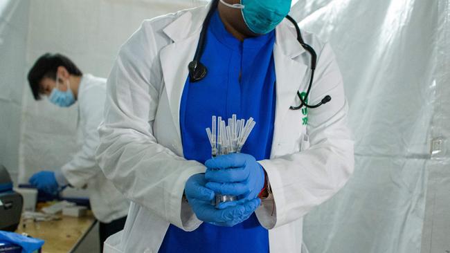 A health worker carries syringes to administer Pfizer COVID-19 vaccines at the opening of a new vaccination site in Harlem New York. Picture: AFP.