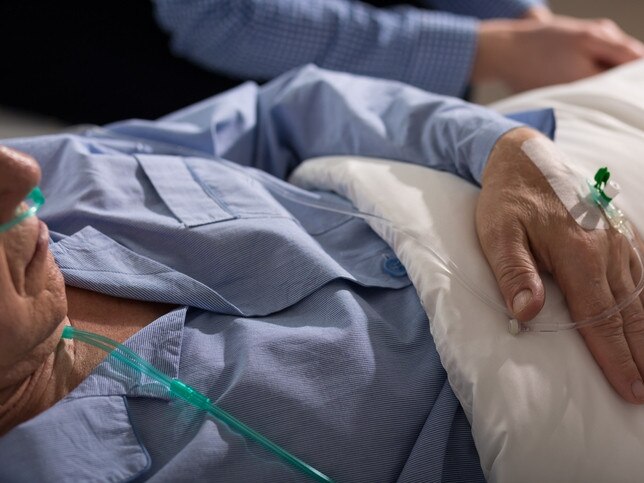 Close-up of terminally ill man's hand with dripEuthanasiaElderlyOldSickRendezView