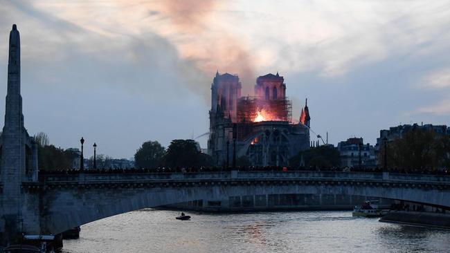 Firefighters douse flames rising from the roof at Notre Dame Cathedral. Picture: AFP