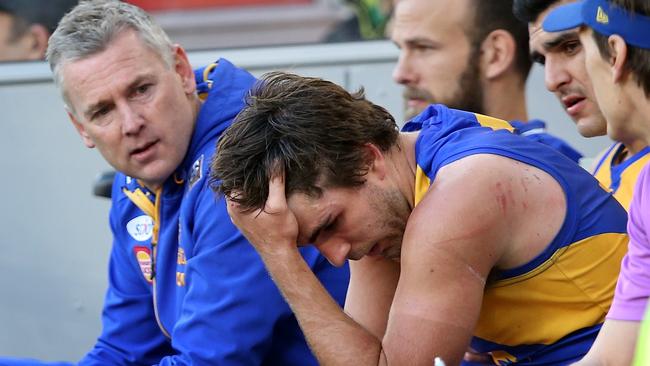 Andrew Gaff holds his heads in his hands as he’s consoled by West Coast coach Adam Simpson (left). Photo: Getty Images