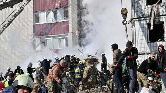 Rescuers search for survivors in the rubble after Russian missile strikes targeted several Ukrainian cities overnight. Picture: AFP.