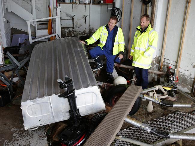 Terrigal Marine Rescue assess the damage after waves crashes into their Terrigal Headquaters during from Major storm in 2016. Pictures Mark Scott