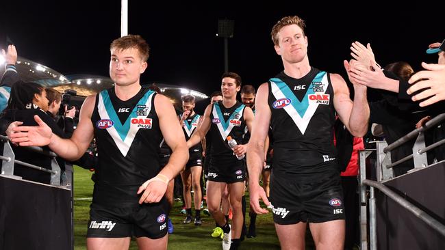 Ollie Wines and Tom Jonas lead Port Adelaide off the field on Sunday night. Picture: Mark Brake (Getty).