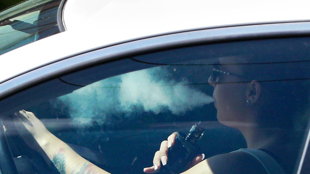 Vaping while driving. Surfers Paradise on the Gold Coast. ** NO BYLINE **