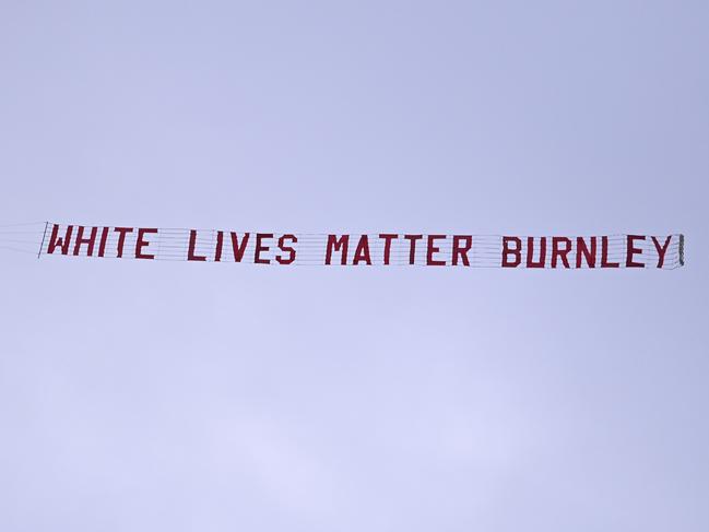 A plane towing a banner reading White Lives Matter Burnley flies above the stadium during the during the English Premier League soccer match between Manchester City and Burnley at Etihad Stadium, in Manchester, England, Monday, June 22, 2020. (AP Photo/Shaun Botterill,Pool)