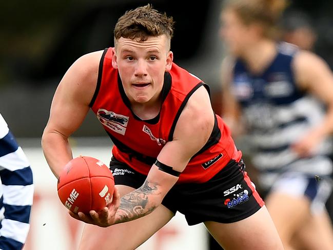 Samuel Wilson of Romsey handballs during the round 16 Riddell District Football Netball League 2023 Bendigo Bank Seniors match between Romsey and Macedon at Romsey Park in Romsey, Victoria on August 5, 2023. (Photo by Josh Chadwick)